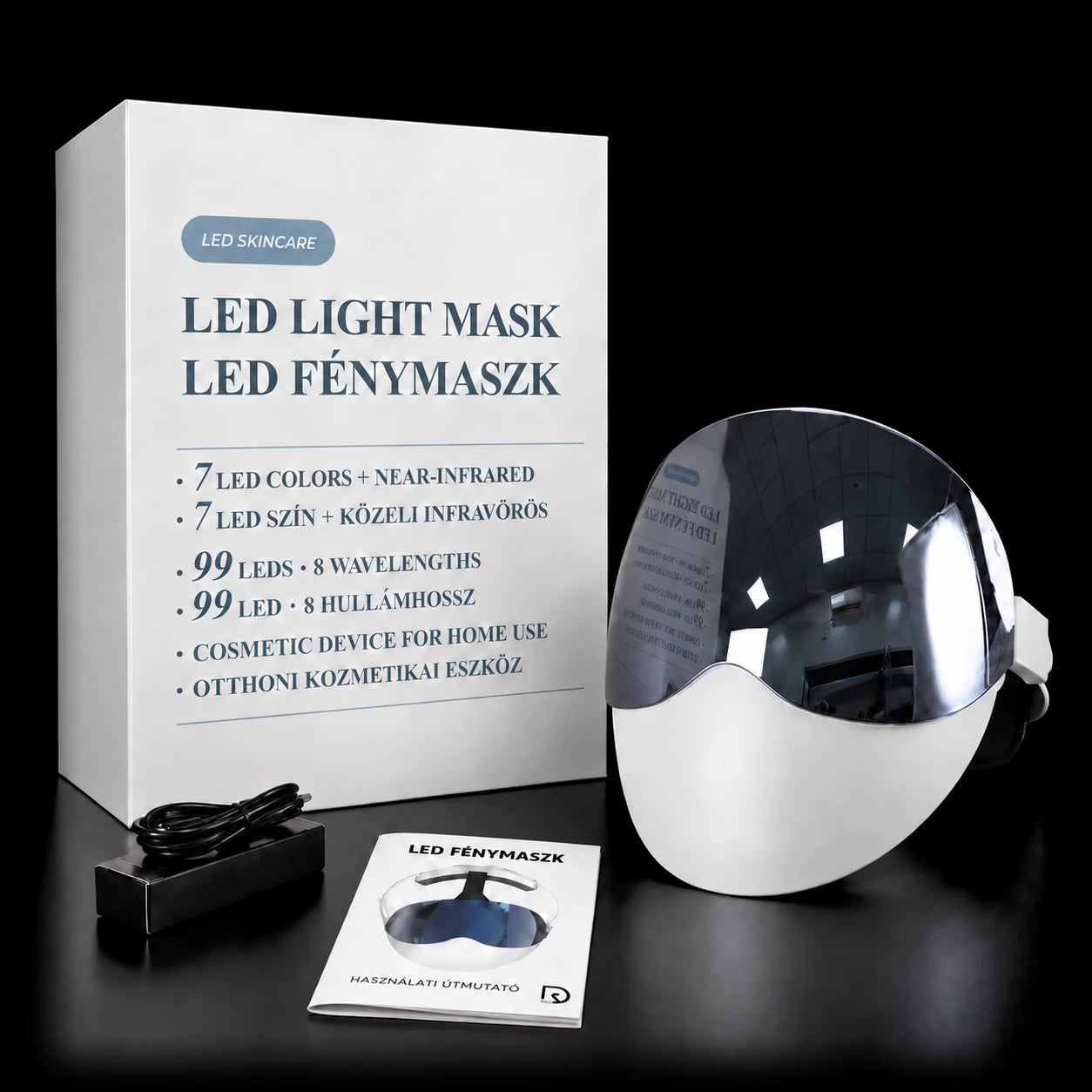 Presentförpackningen med LED-ljusmasken bredvid, och framför dem USB-C-kabeln och den tryckta bruksanvisningen