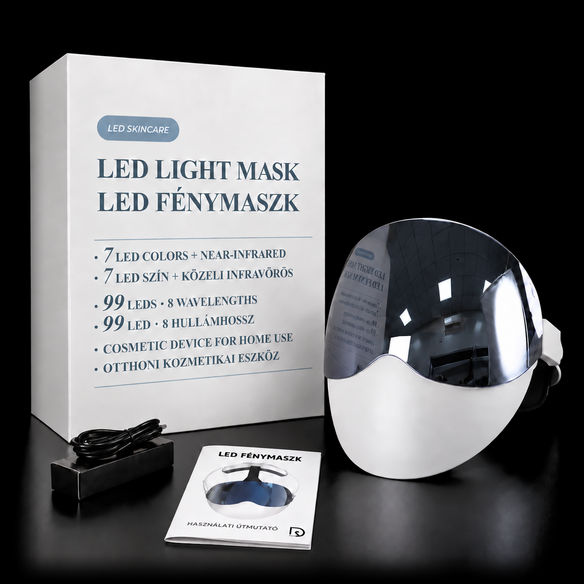 Presentförpackningen med LED-ljusterapimasken bredvid, och framför dem USB-C-kabeln och den tryckta bruksanvisningen